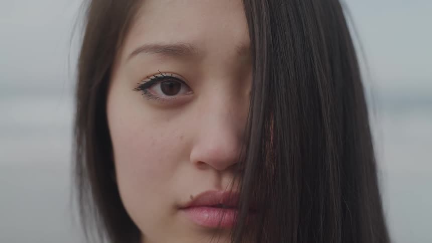 An asian woman looking into the camera