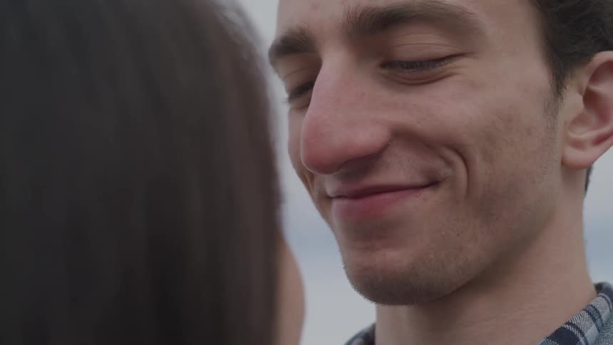Man smiles down at a woman