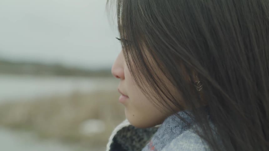 An asian woman blinking