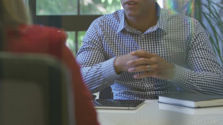 Man talks to woman in office