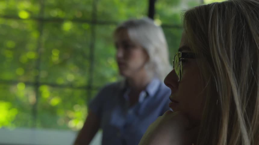 Women listening and talking to a coworker at the office