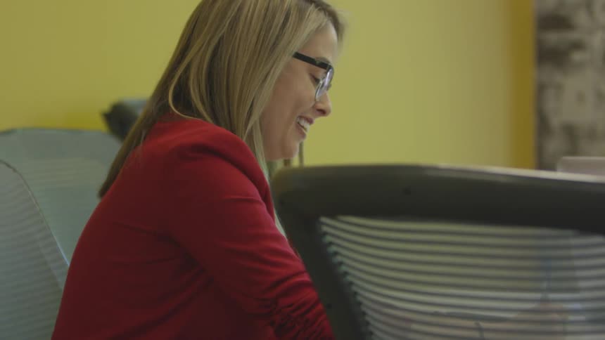 Woman talking and taking notes on an office