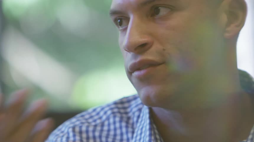 A man gestures with his hands while talking
