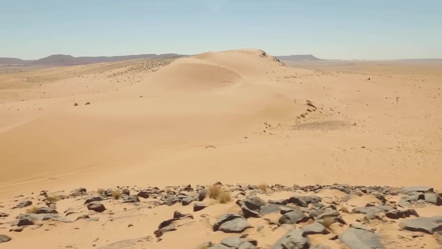 An suv travels through a desert