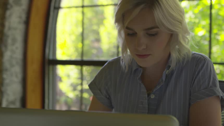 A woman is working on a laptop