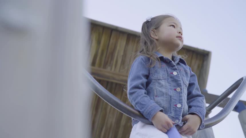 A little girl playing in a park