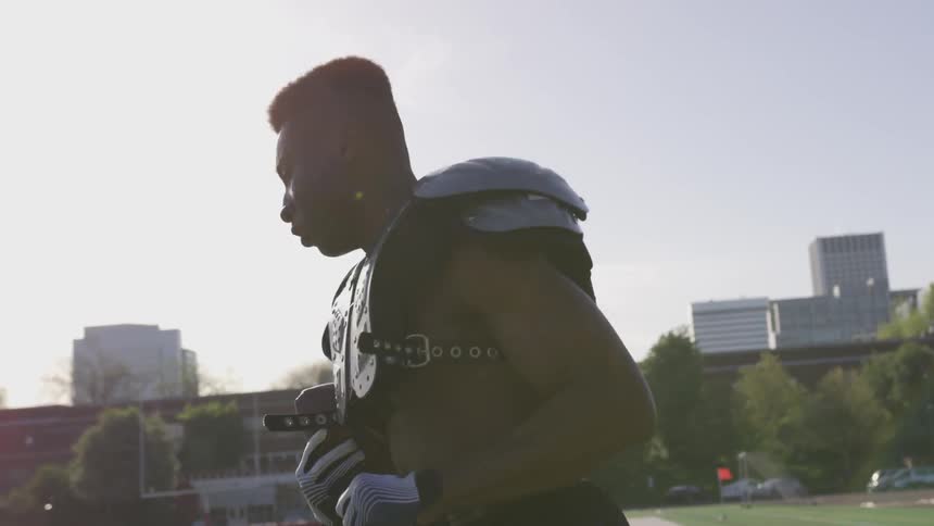 A football player does a footwork drill