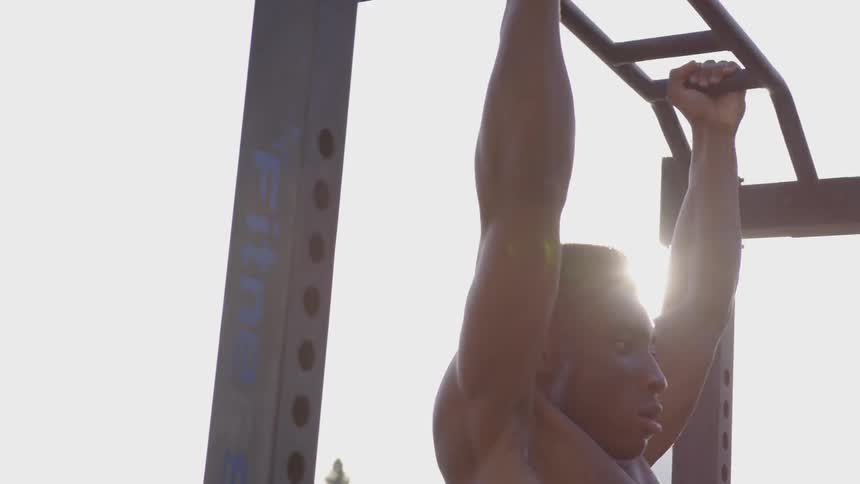 A man doing pull ups outside