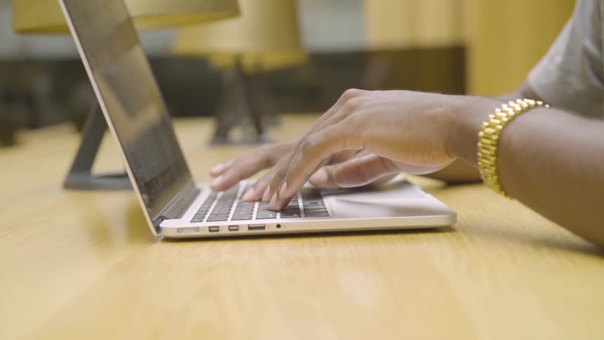 Someone types on a laptop