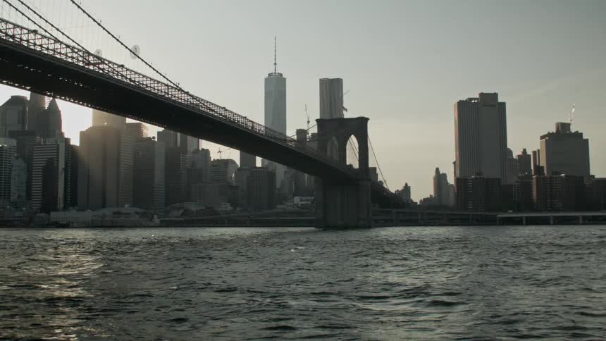 Bridge leading to a city during sunrise