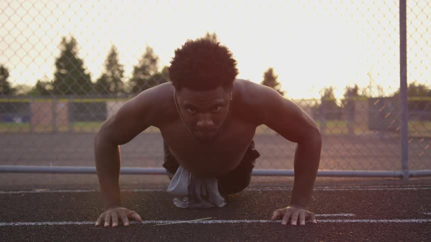 A man does push ups on the court