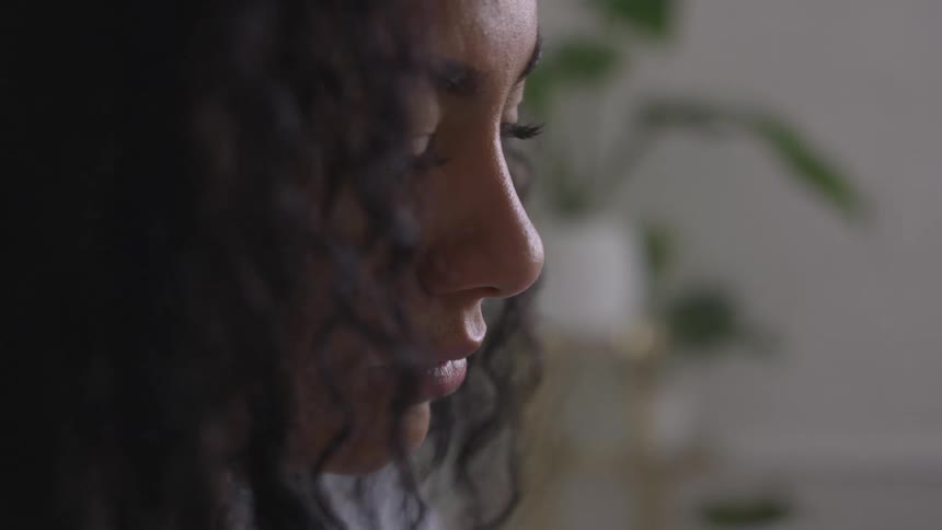 A young woman stares ahead