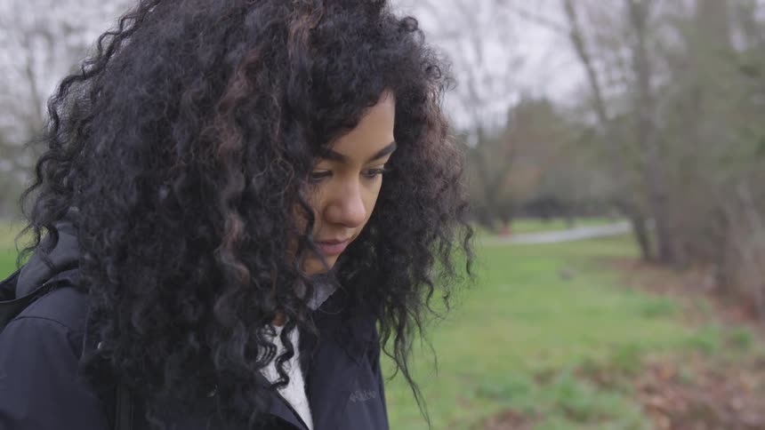 A girl stares sadly at something off screen