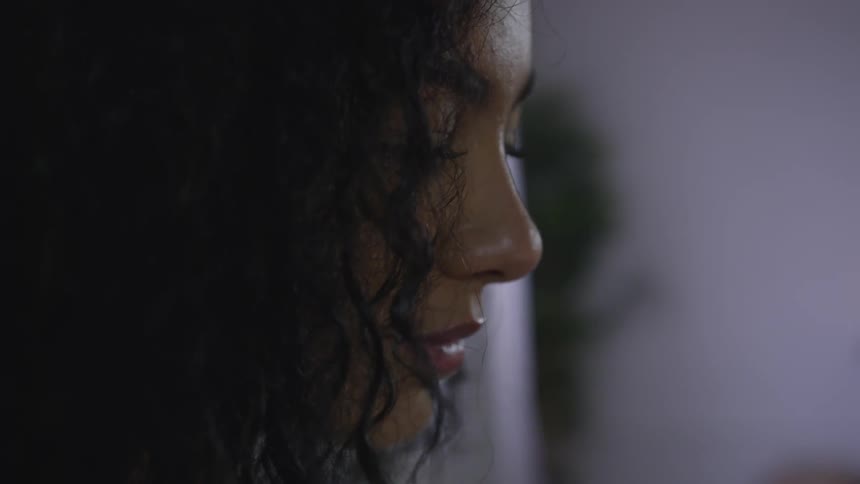 A black woman in a room thinking