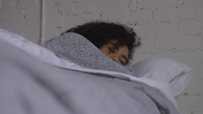 Woman sleeps in bed