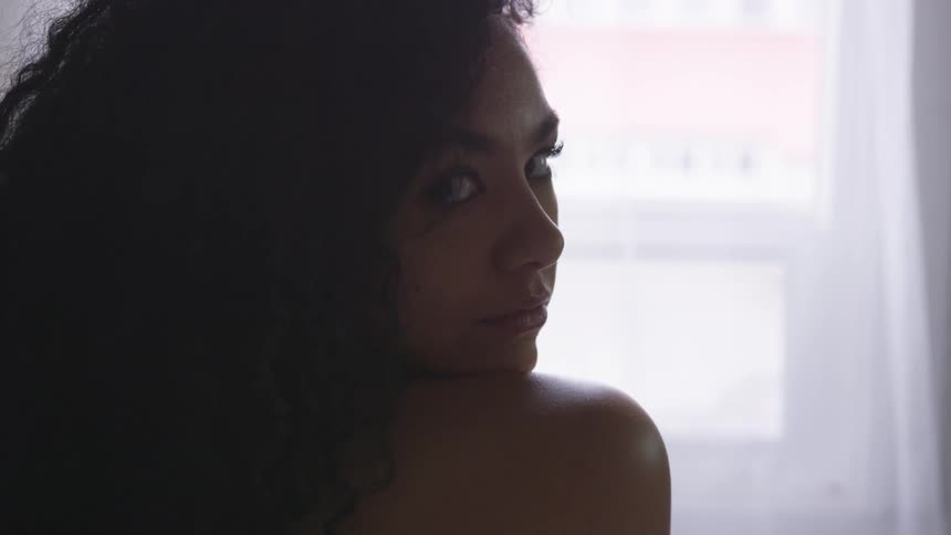 A woman turns to look at the camera