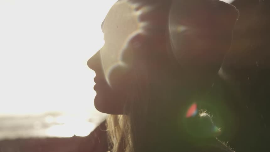 A young girl looks into the distance as snow falls