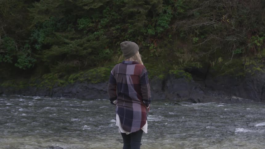 Woman standing next to a river