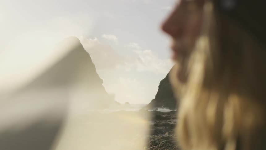 A woman looks out at the ocean
