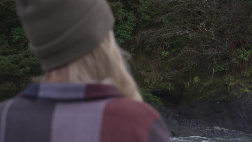 A young girl looks across a river