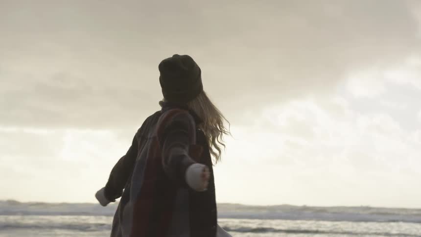 A woman is outside spinning around