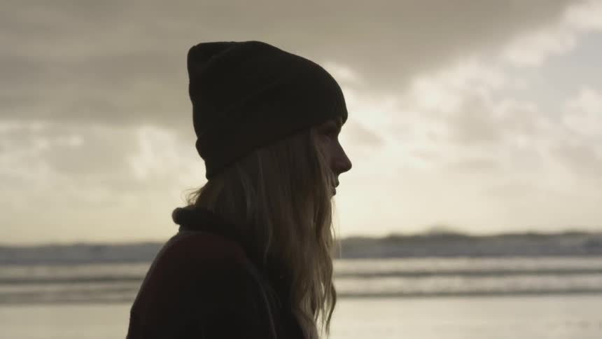 A woman staring out towards the sea