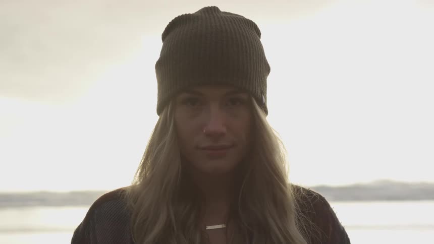 A woman stares into the camera