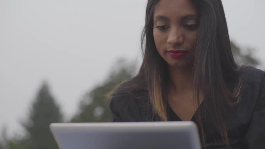 A young woman works on her laptop