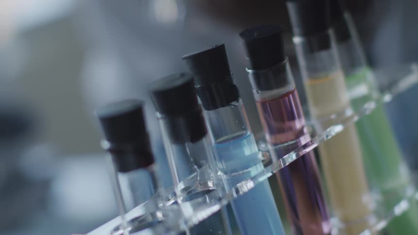 Stoppered test tubes with different colored liquid in a holder in a lab