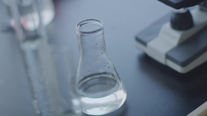 Water ripples in a flask on a laboratory counter