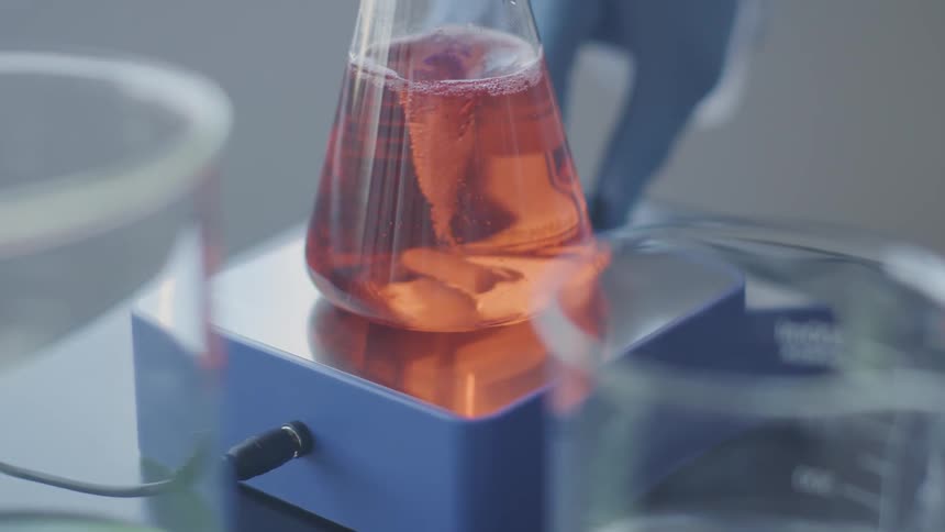 Red liquid in test tube rotates in the laboratory