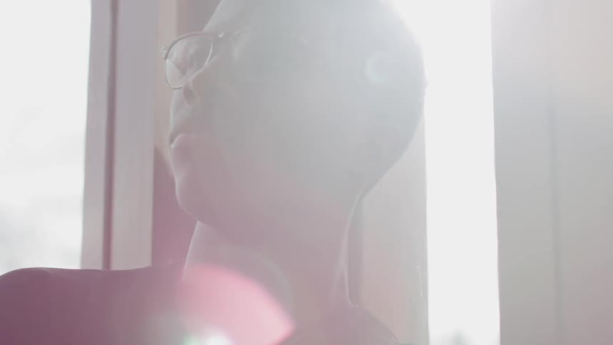 Young man sitting on a room on a sunny day