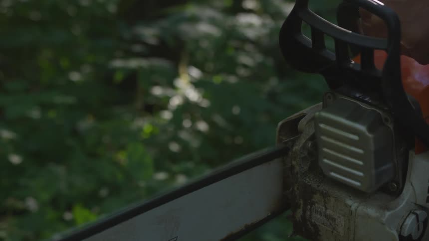 A man uses an electric saw