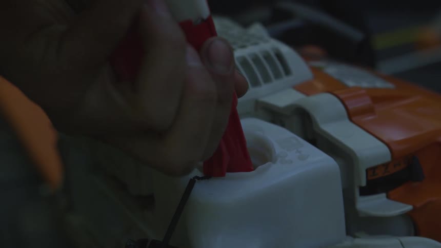 A person is putting oil in an engine