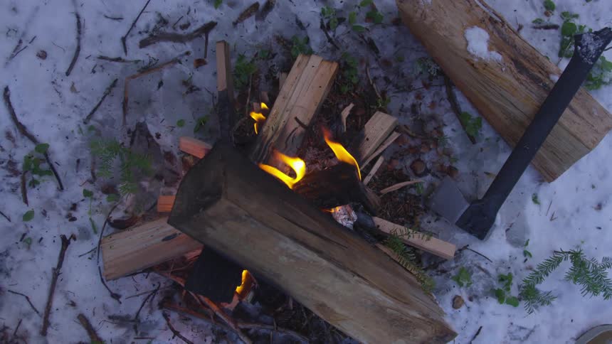 A man made fire on the snow covered ground