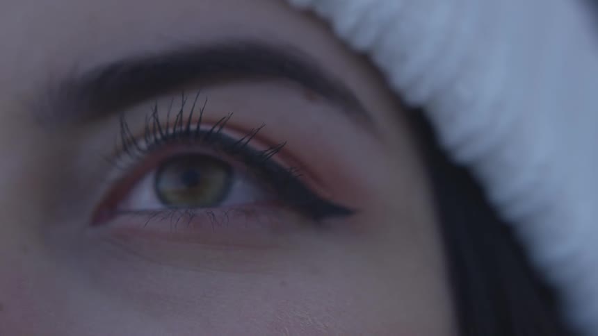 A woman with long lashes blinks