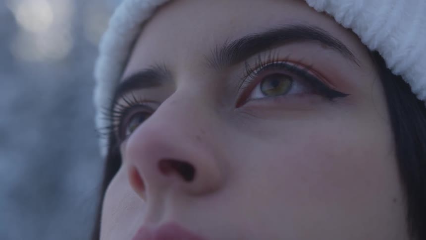 A woman looks up toward the sky