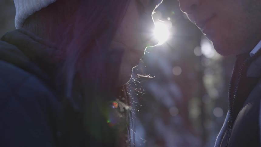 Couple standing close to each other touching heads