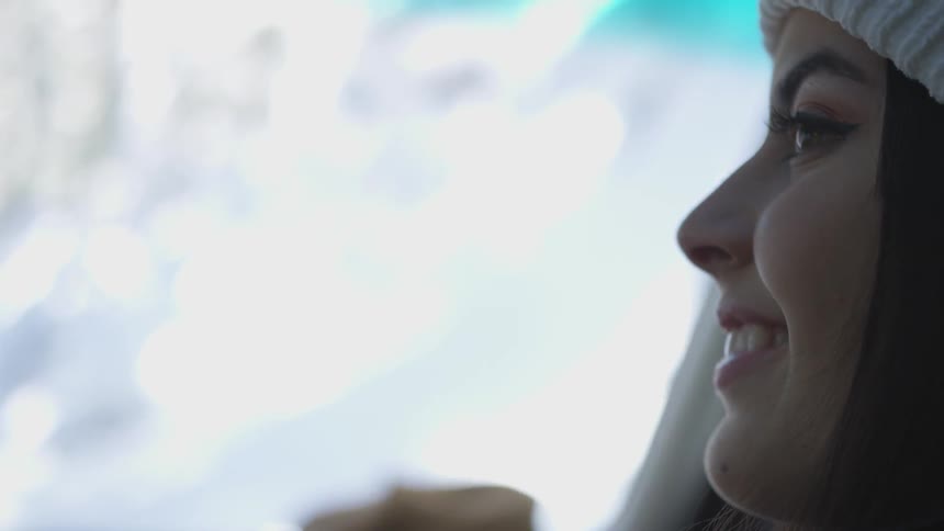 A woman looks out the window smiling