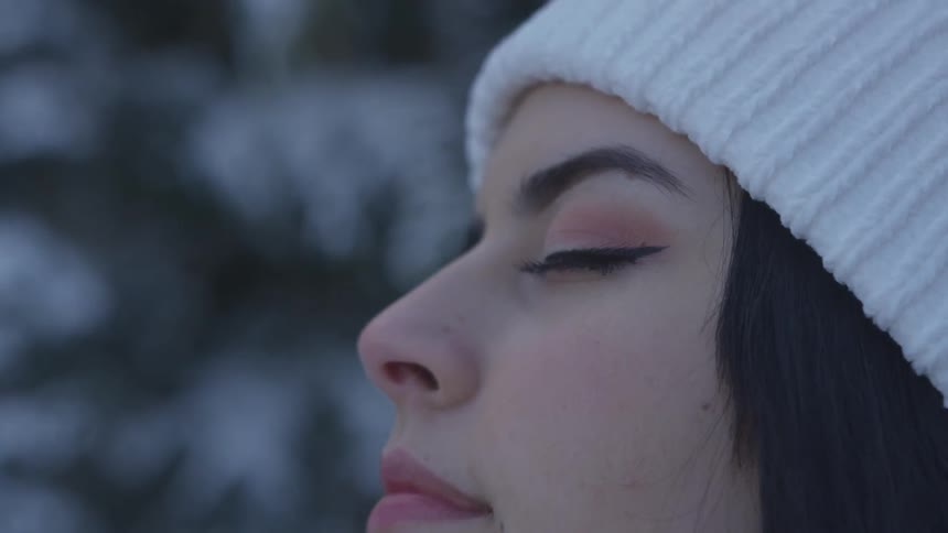 Close up of young woman with eyes closed in forest