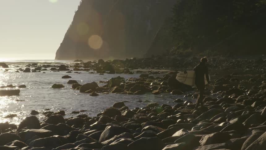 Man Surfing And Exploring Forest And Ocean In Pacific Northwest