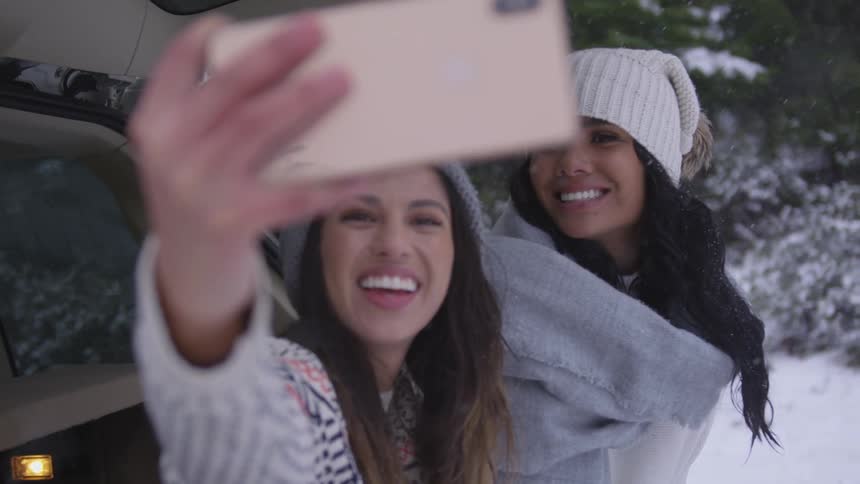 Two women take a selfie in the snow