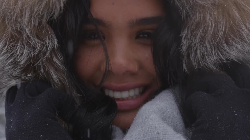 A woman smiles into the camera