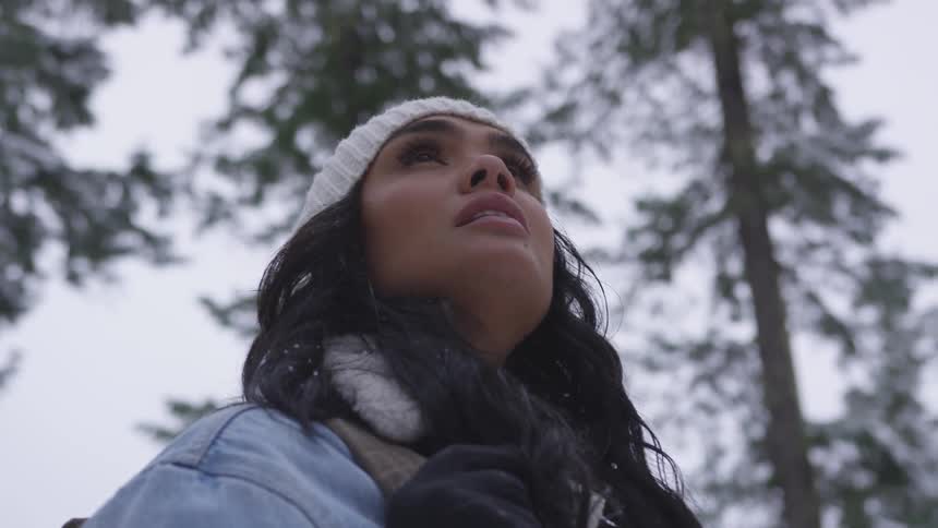 A young girl looks up towards the sky