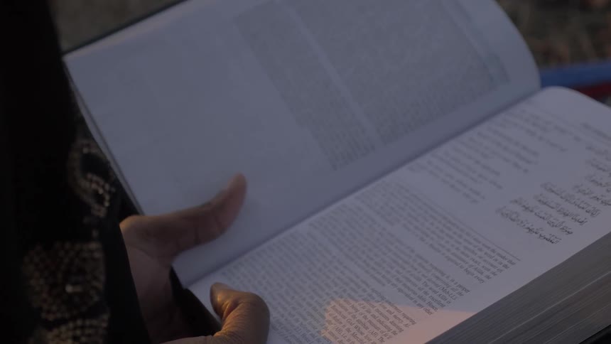 A person reads a book on their lap