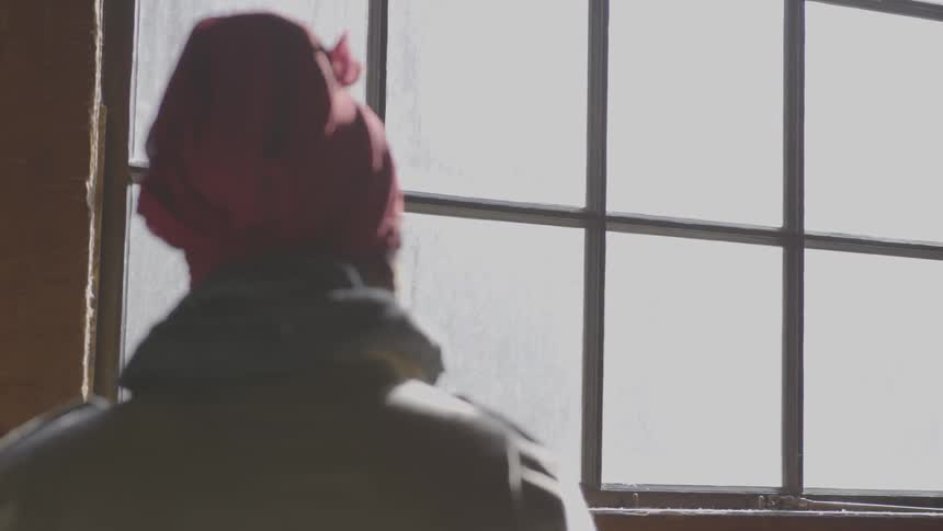 Black woman looking out the window