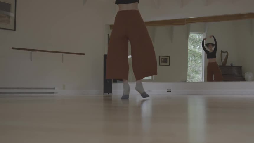 A woman dances in a studio