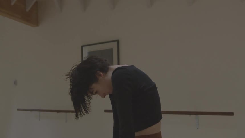 A woman dances indoors