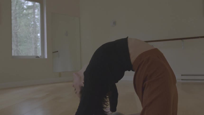 A woman pulls herself up from the floor