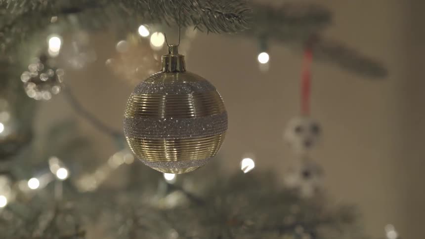 A christmas ornament on a white artificial christmas tree
